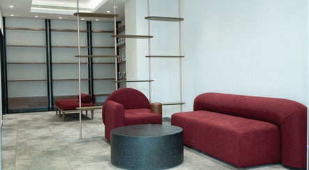 Modern lounge area with red seating at MIER BEAUTY LOUNGE, Abu Dhabi, Abu Dhabi, AE.