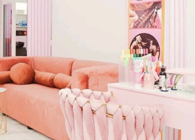 Elegantly decorated lounge at Nicky's hub in Johannesburg, Gauteng, ZA with plush seating and beauty products on display.