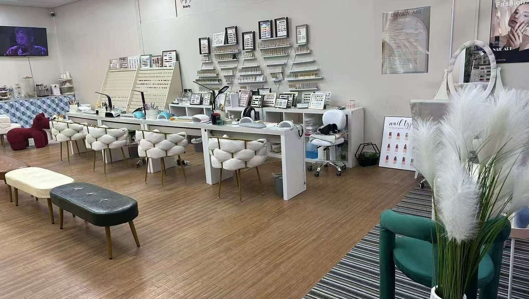 Spacious nail salon interior at Uniview Art, Edinburgh, Scotland, GB with plush seating and manicure stations.