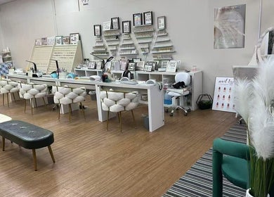 Spacious nail salon interior at Uniview Art, Edinburgh, Scotland, GB with plush seating and manicure stations.