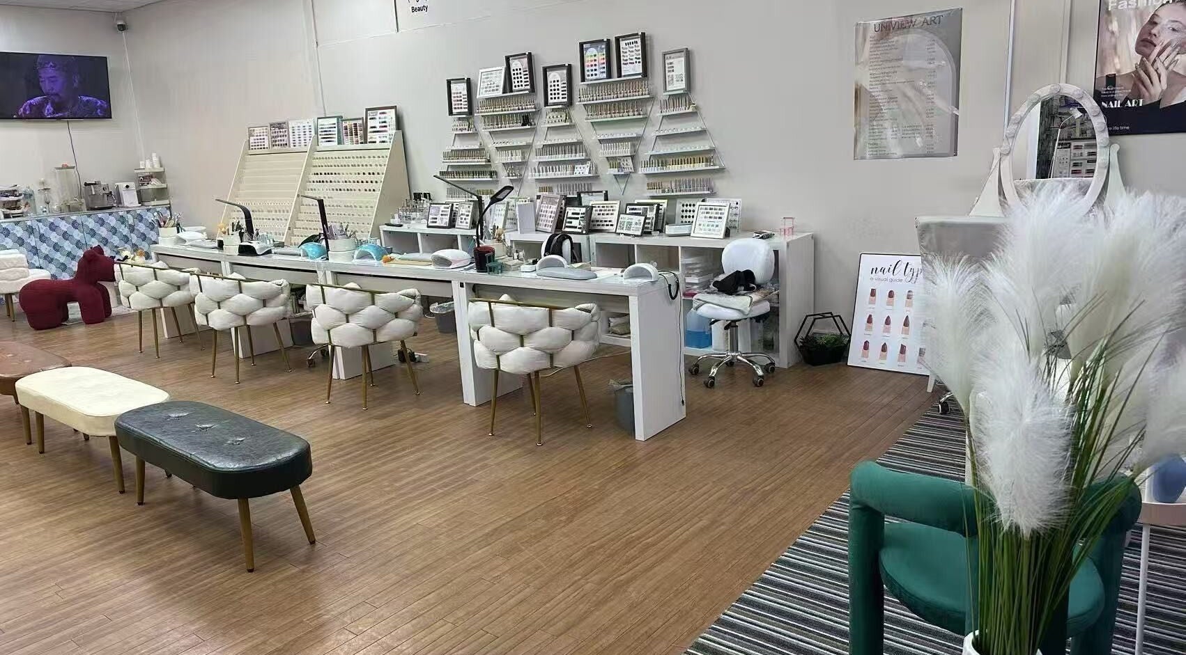 Spacious nail salon interior at Uniview Art, Edinburgh, Scotland, GB with plush seating and manicure stations.