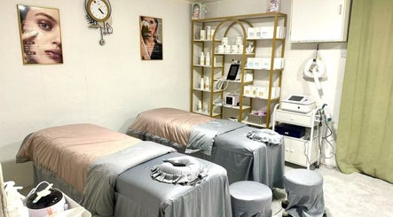 Relaxing treatment room at Uniview Art, Edinburgh, Scotland, GB with two massage tables and beauty equipment.