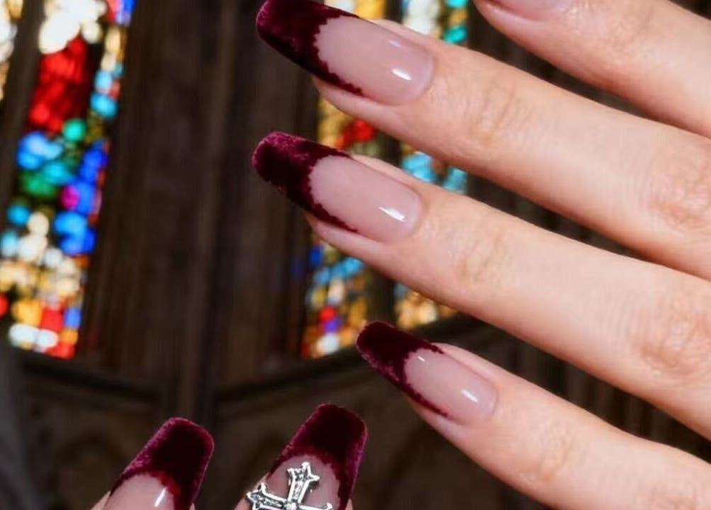 Elegant burgundy velvet nails at 14 haymarket terrace, Edinburgh, Scotland, GB with a cathedral backdrop.