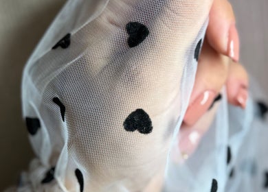 Delicate mesh with hearts held at She & He Studio, Llanybydder, Wales, GB. Elegant beauty representation.