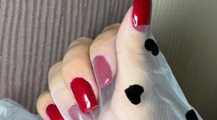 Stunning red manicured nails at She & He Studio, Llanybydder, Wales, GB wrapped in elegant white mesh.