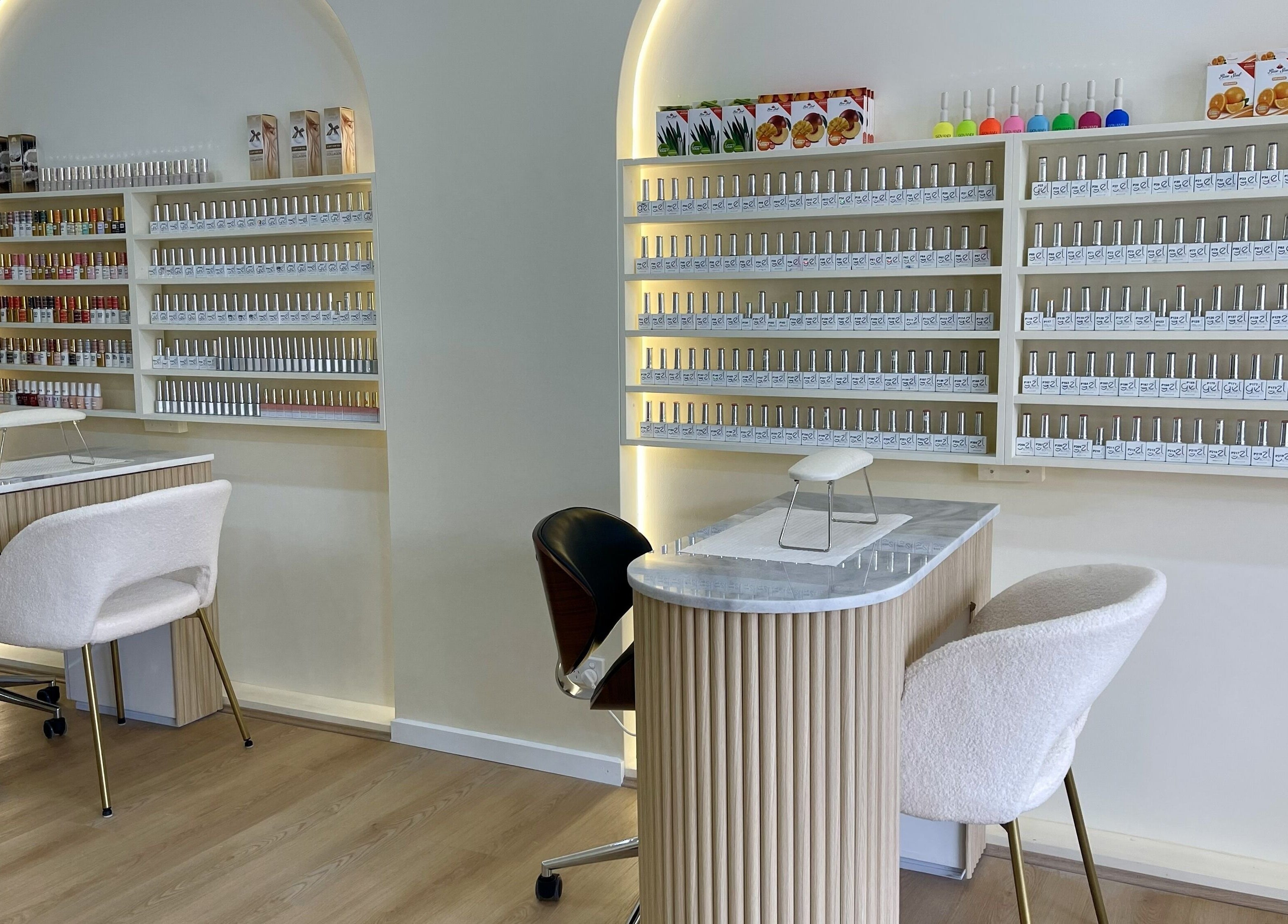 Polished interior of Posh Nails Boutique in Melbourne, Victoria, AU with stylish seating and nail polish display.