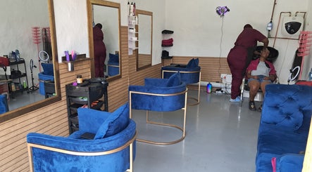 Modern salon interior with blue chairs at Rooted Hair Co, Pretoria, Gauteng, ZA.