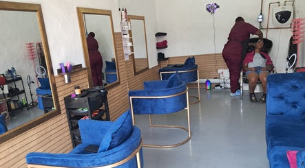 A stylist works with a client in a cozy salon at Rooted Hair Co, Pretoria, Gauteng, ZA.