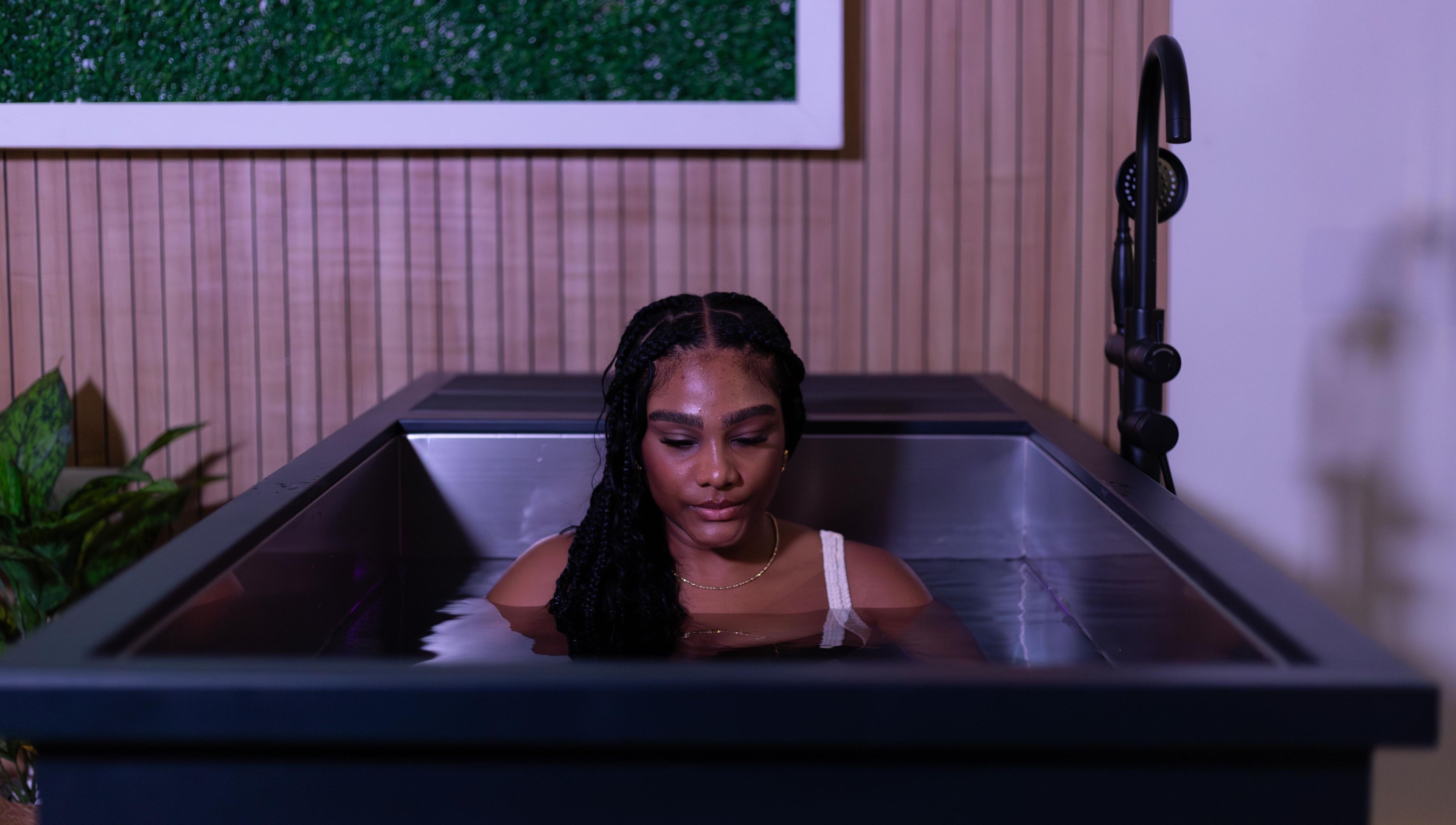 Woman relaxing in ice bath at DARR Ice Bath Curacao, Willemstad, CW, with calming ambiance.