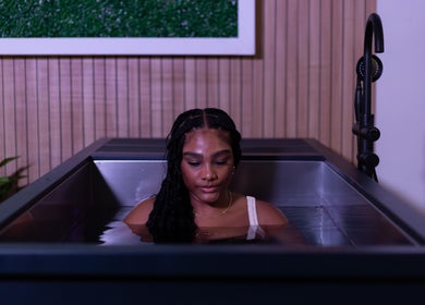 Woman relaxing in ice bath at DARR Ice Bath Curacao, Willemstad, CW, with calming ambiance.
