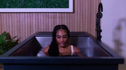 Woman relaxing in ice bath at DARR Ice Bath Curacao, Willemstad, CW, with calming ambiance.