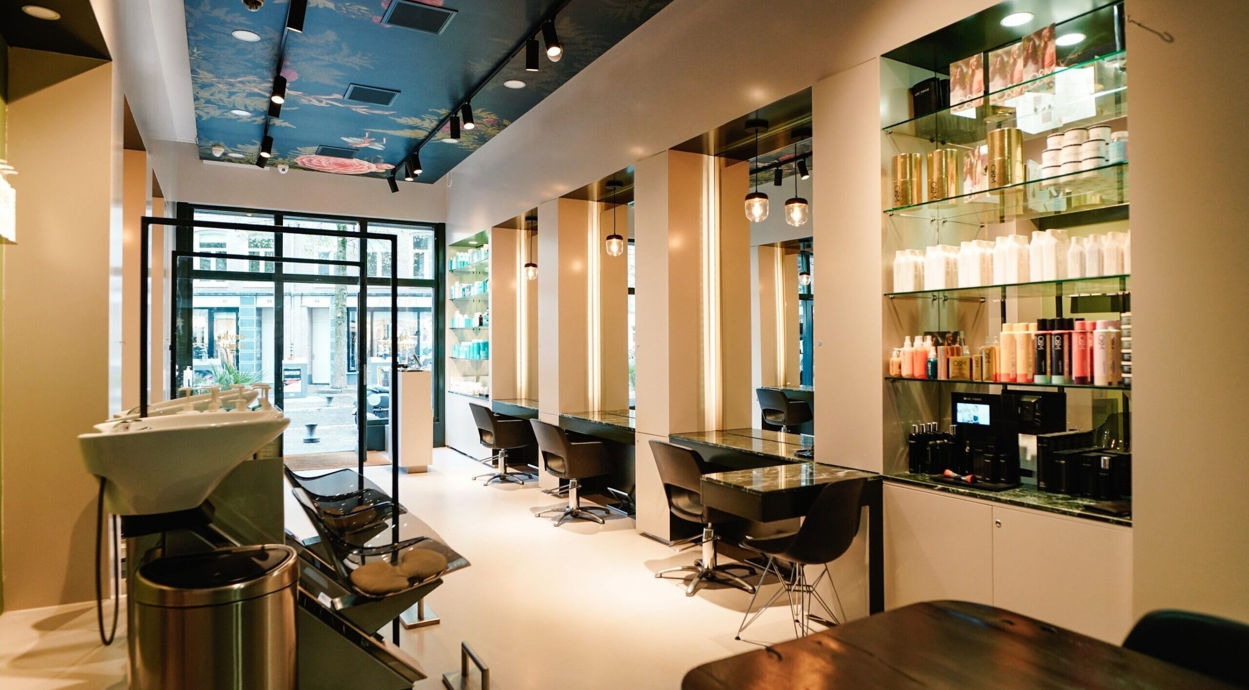 Modern salon interior at Hair salon De Pijp, Amsterdam, Noord-Holland, NL with elegant styling stations.