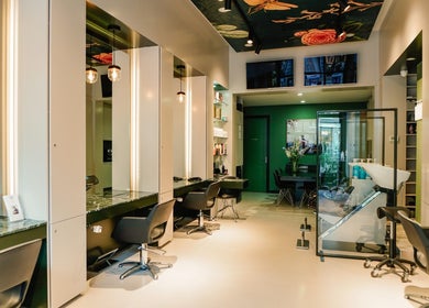 Modern interior of Hair Salon De Pijp in Amsterdam, Noord-Holland, NL, showcasing sleek styling stations.