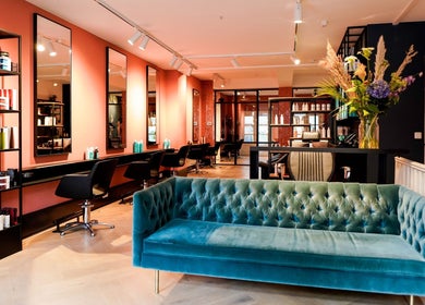 Chic interior of Hair salon Westerstraat, Amsterdam, Noord-Holland, NL, with styling chairs and vibrant decor.