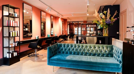 Chic interior of Hair salon Westerstraat, Amsterdam, Noord-Holland, NL, with styling chairs and vibrant decor.