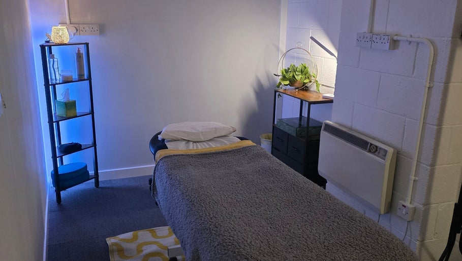 Soothing treatment room at The Thera Pt, Blackburn, Scotland, GB with a softly-lit ambiance and massage table.