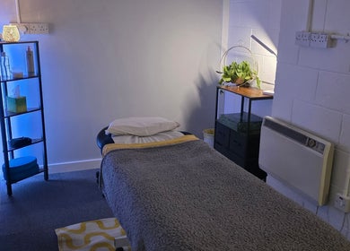 Soothing treatment room at The Thera Pt, Blackburn, Scotland, GB with a softly-lit ambiance and massage table.