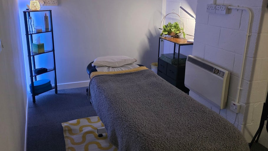 Calm therapy room at The Thera Pt in Blackburn, Scotland, GB with treatment table and soothing decor.
