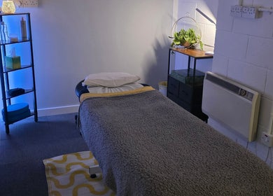 Calm therapy room at The Thera Pt in Blackburn, Scotland, GB with treatment table and soothing decor.