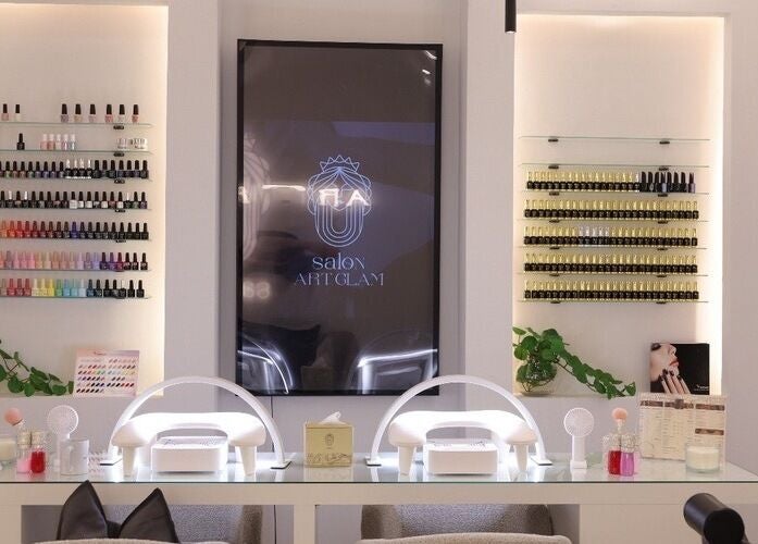 Art Glam salon in Riyadh, featuring chic nail polish display and modern workstations.