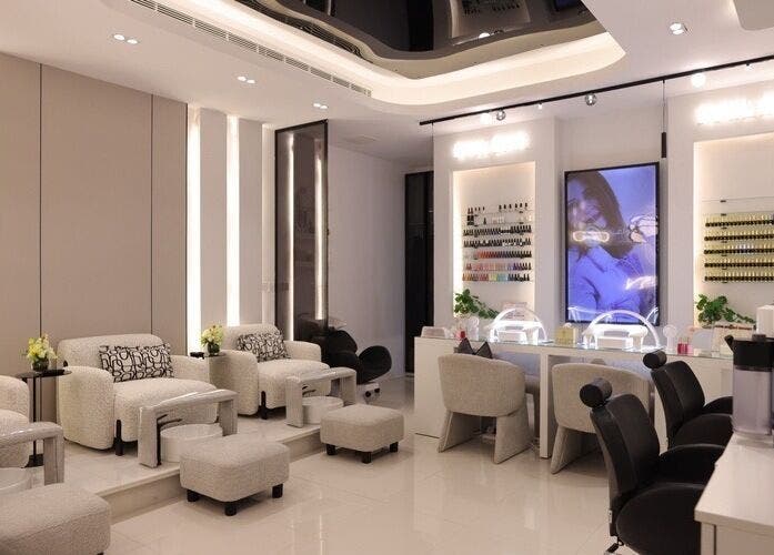 Luxurious beauty lounge at Art Glam, Riyadh, Riyadh Province, SA, showcasing elegant seating and nail care stations.