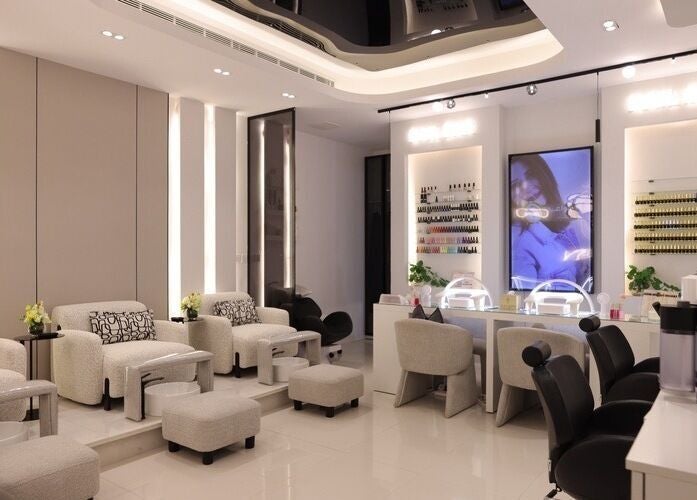 Luxurious beauty lounge at Art Glam, Riyadh, Riyadh Province, SA, showcasing elegant seating and nail care stations.