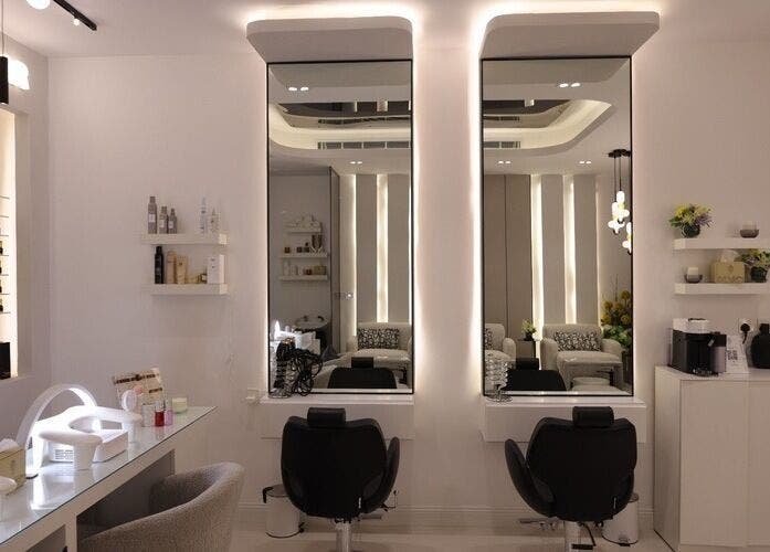 Modern salon interior at Art Glam, Riyadh, Riyadh Province, SA, featuring sleek mirrors and stylish chairs.