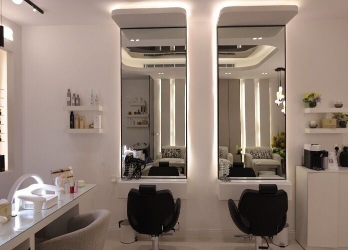 Modern salon interior at Art Glam, Riyadh, Riyadh Province, SA, featuring sleek mirrors and stylish chairs.