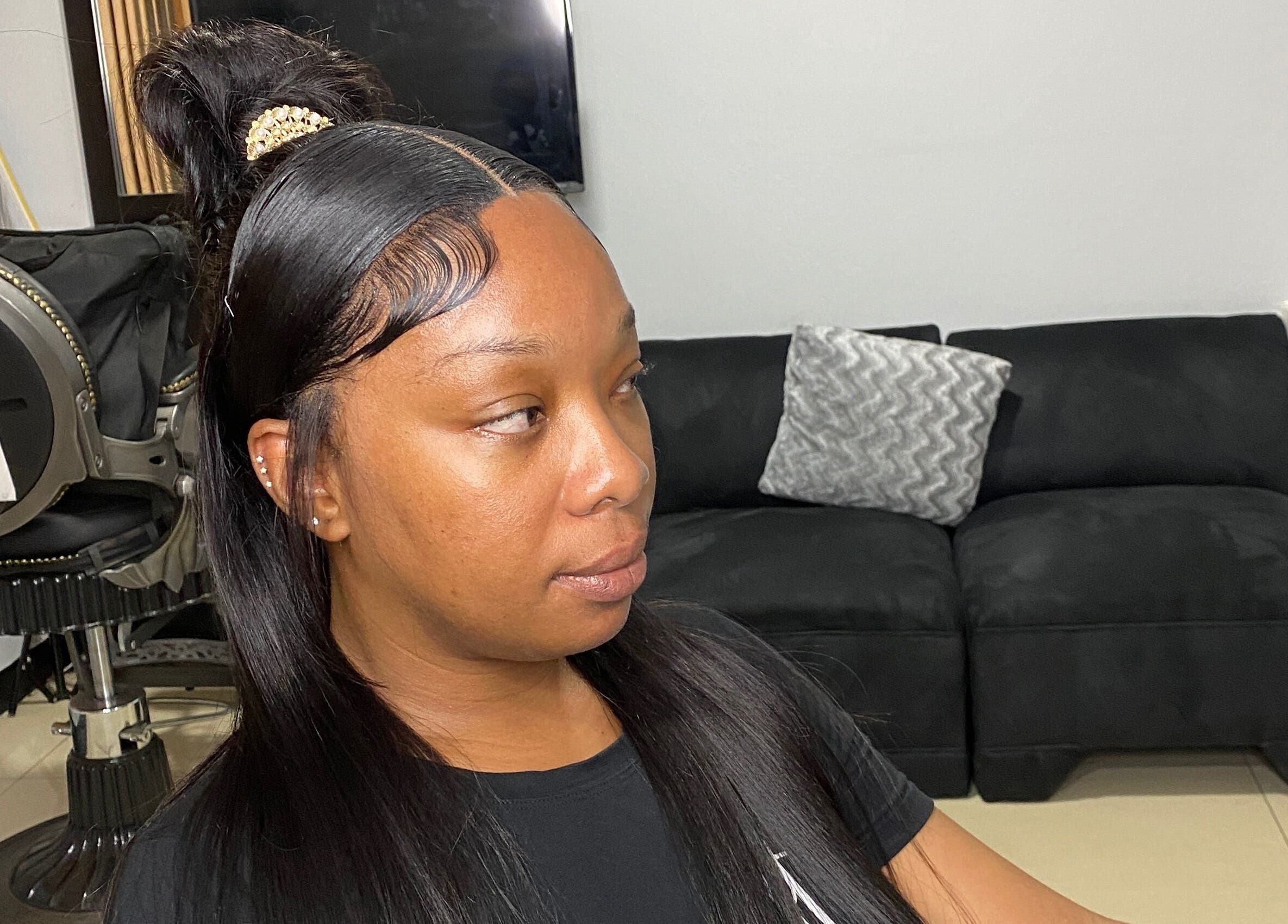 Client with sleek hairstyle at HAIRBYDAE98 in Kingston, JM, showcasing expert salon care.