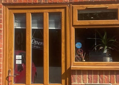Cosmic Glow Room entrance with wooden door in Copthorne, England, GB showcasing open sign.