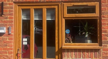 Cosmic Glow Room entrance with wooden door in Copthorne, England, GB showcasing open sign.
