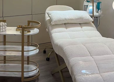 Elegant treatment room at Cosmic Glow Room, Copthorne, England, GB featuring a plush treatment bed.