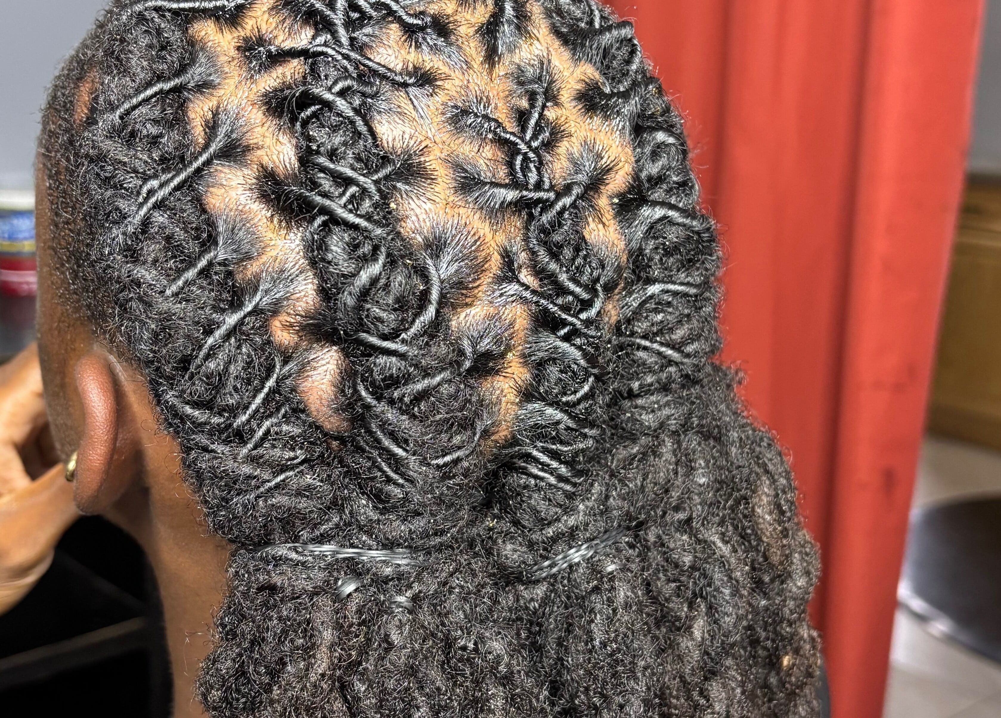 Close-up of intricately styled locs at Loc’d n Kee, The Quarter, AI.