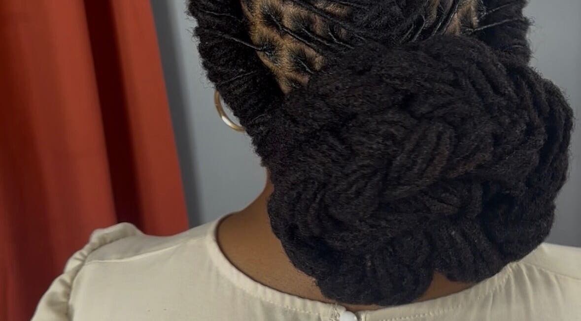 Intricate loc bun hairstyle at Loc’d n Kee, The Quarter, AI.