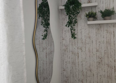 Elegant mirror and lush plants at Marinez Maia Aesthetic & Massage, Orlando, Florida, US.