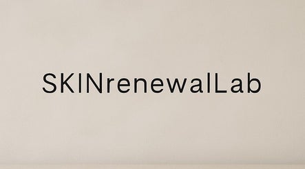 Clean SKINrenewalLab logo on textured wall in Bury, England, GB, showcasing minimalist design.