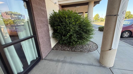 Entrance of Concierge Cosmetics in Fort Collins, Colorado, US, nestled by greenery and a welcoming sign.