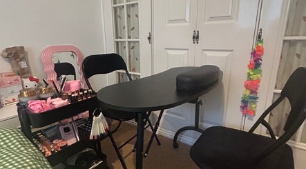 Manicure station at Popsiesmanis, Southampton, England, GB with a pink mirror and beauty products on display.