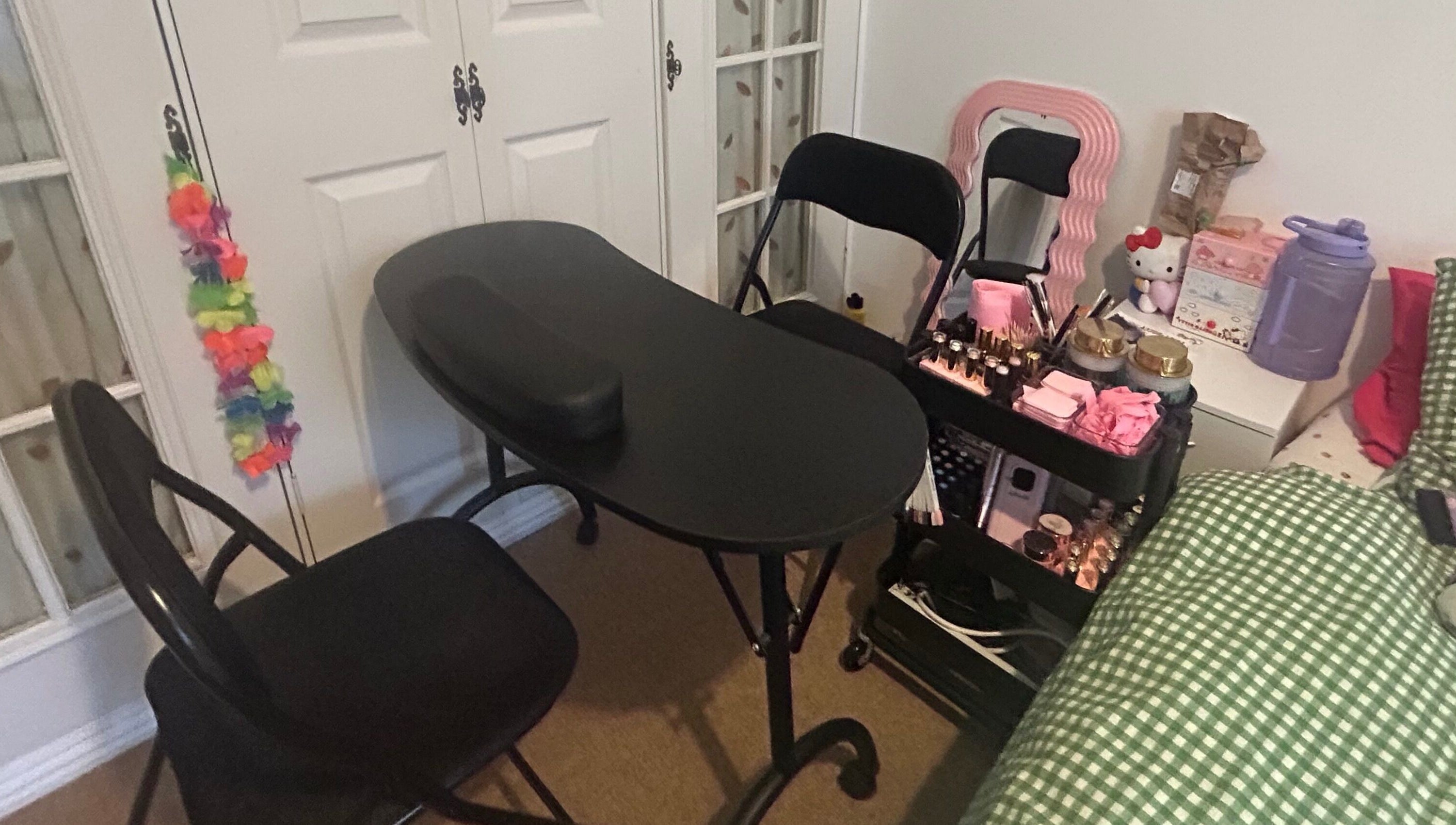Nail workspace at Popsiesmanis, Southampton, England, GB, with a black table and beauty essentials.