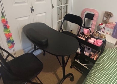 Nail workspace at Popsiesmanis, Southampton, England, GB, with a black table and beauty essentials.