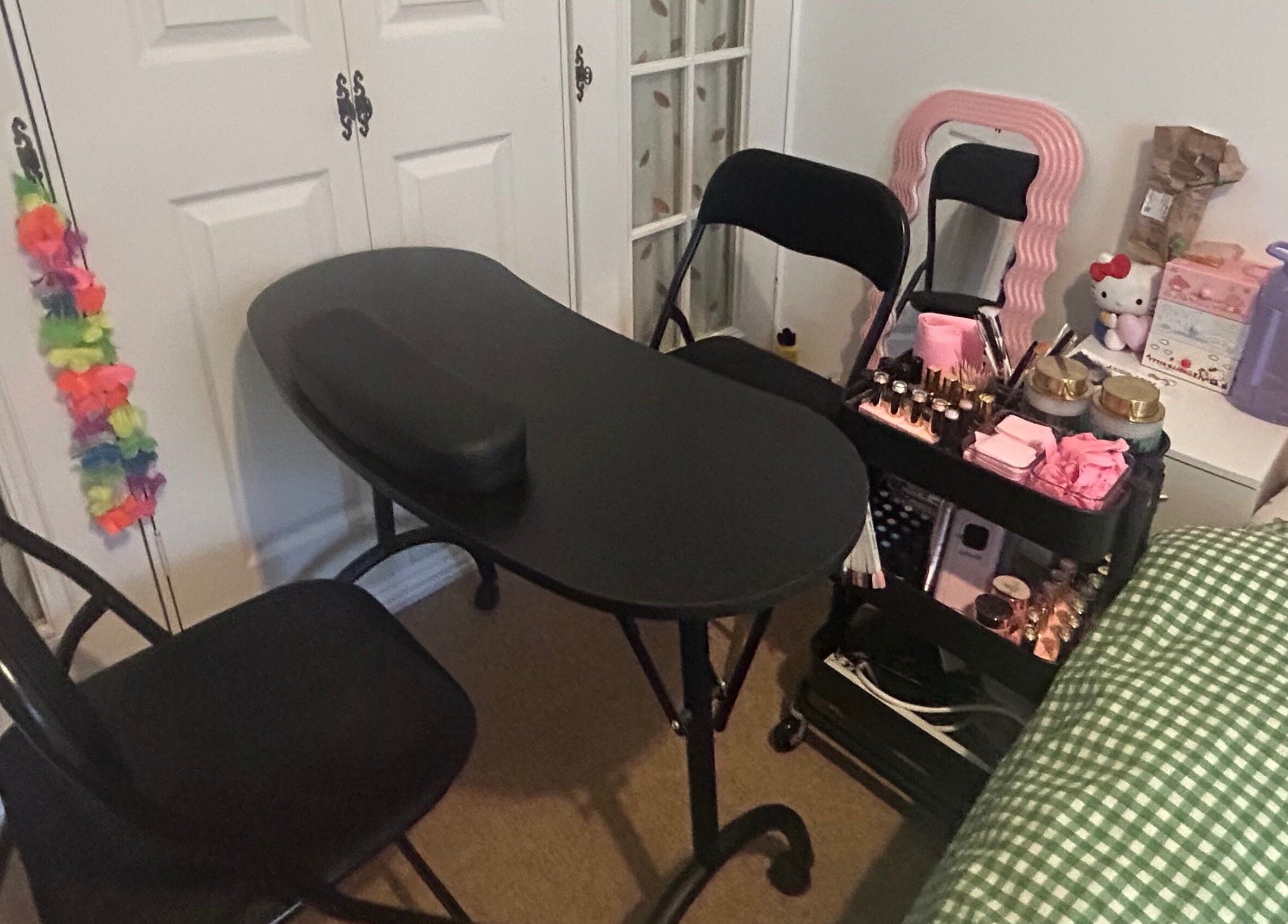 Nail workspace at Popsiesmanis, Southampton, England, GB, with a black table and beauty essentials.