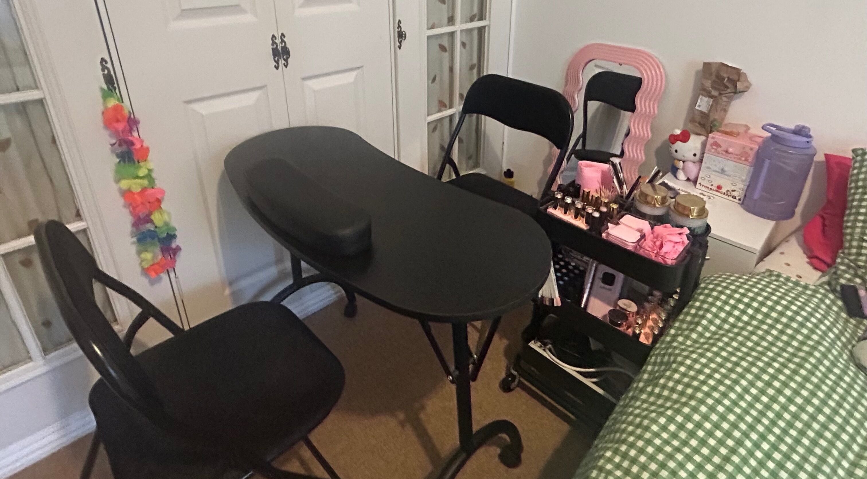 Nail workspace at Popsiesmanis, Southampton, England, GB, with a black table and beauty essentials.