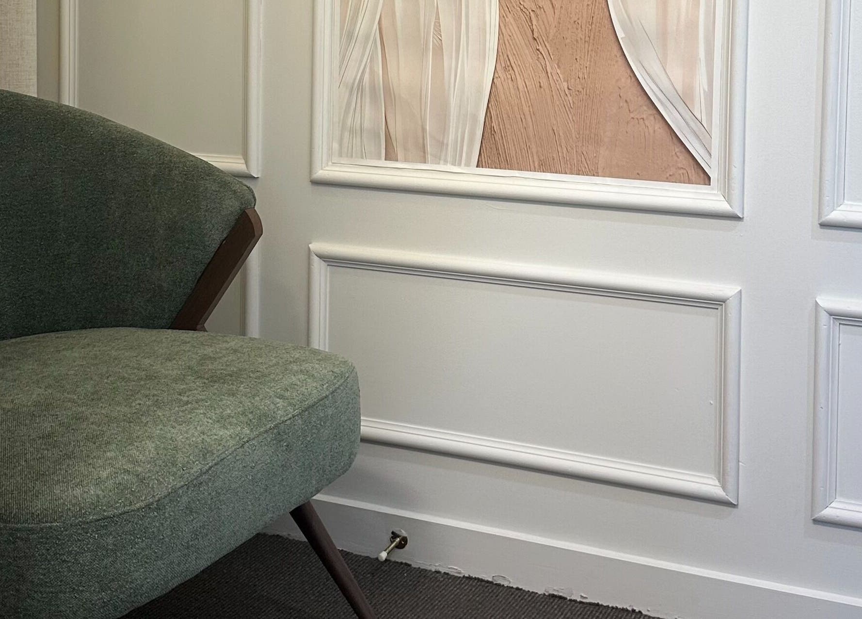 Elegant seating area at Nava Beauty Salon, Christchurch, Canterbury Region, NZ with green armchair.