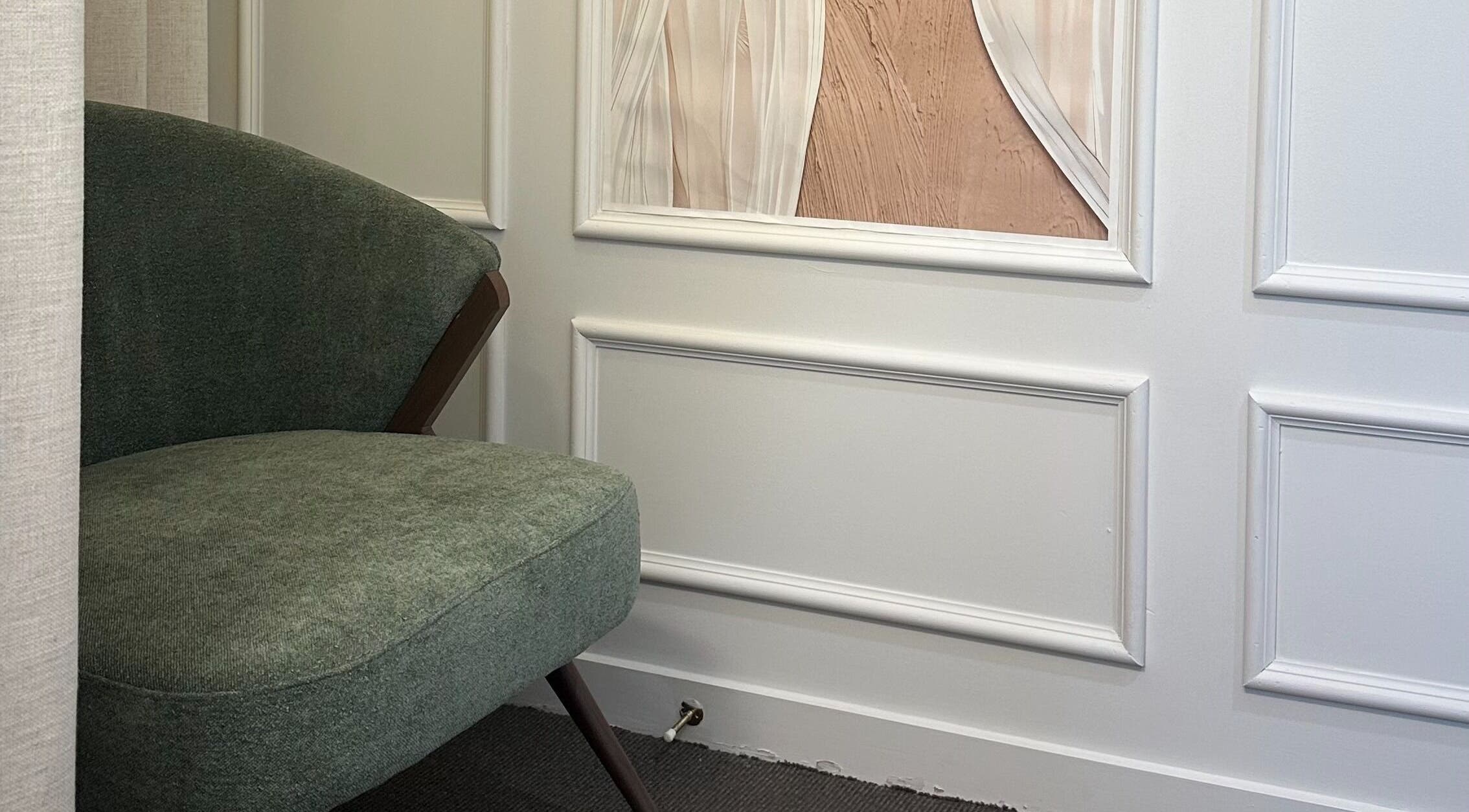Elegant seating area at Nava Beauty Salon, Christchurch, Canterbury Region, NZ with green armchair.