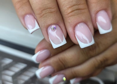 Elegant French manicure with rhinestone detail at Nails by Monika, Torremolinos, Malaga, ES.