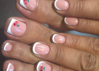 Elegant French pedicure with floral nail art at Nails by Monika in Torremolinos, Malaga, ES.