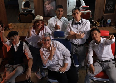Frank Barber Shop team posing at Panamá, Provincia De Panamá, PA with smiles and gestures in a vibrant setting.