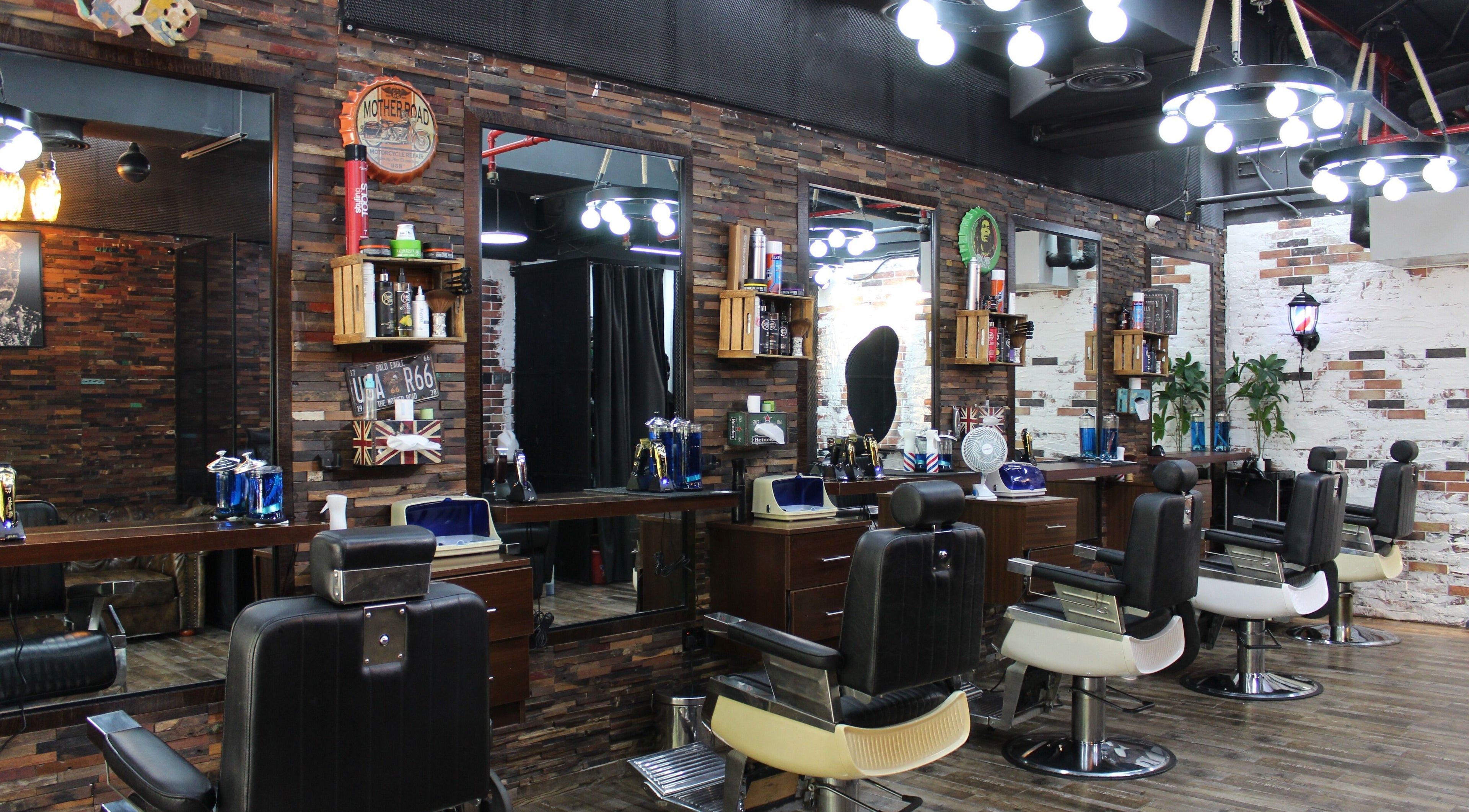 Interior of Tornado Gents Salon - JLT, Dubai, Dubai, AE showcasing vintage barber chairs and rustic décor.