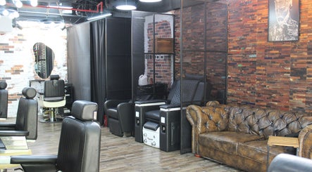 Stylish interior of Tornado Gents Salon - JLT in Dubai, Dubai, AE with modern barber chairs and leather sofa.