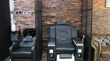 Comfortable salon chair at Tornado Gents Salon - JLT, Dubai, Dubai, AE, with a stylish brick backdrop.